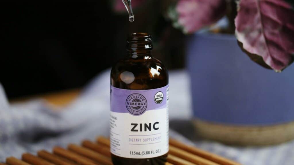 Bottle of zinc for zinc shock therapy on wooden board