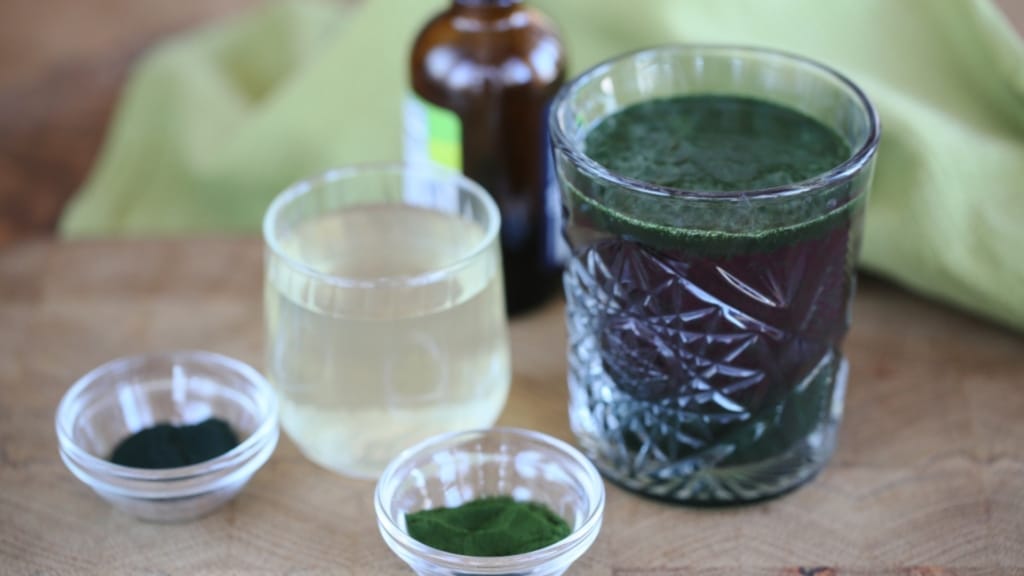 Glass of Brain Detox Tonic and glass of coconut water