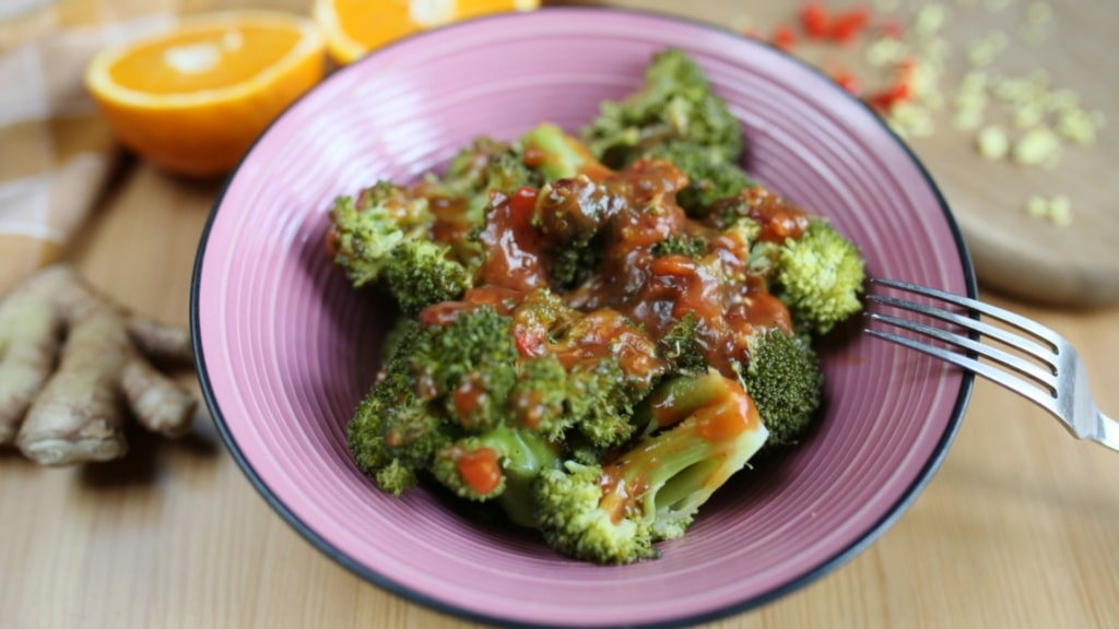 Plate of sweet and spicy broccoli on table